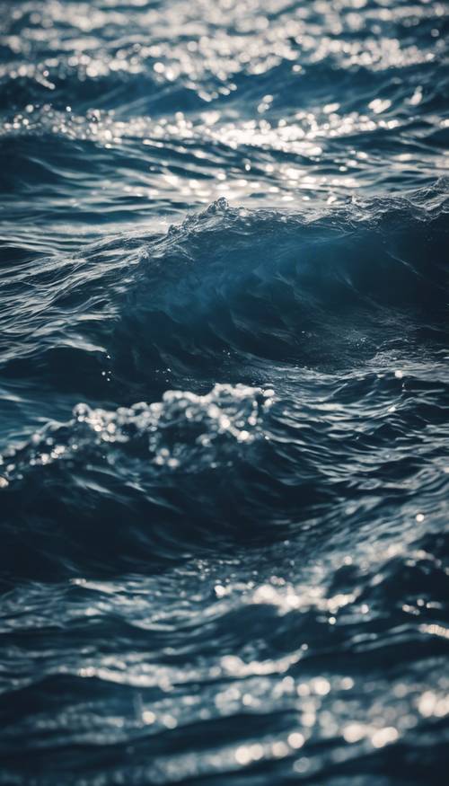 An underwater scene of a deep ocean, emphasizing the mesmerizing texture of dark blue waves. Tapet [59951ae9d0c94a3791f7]