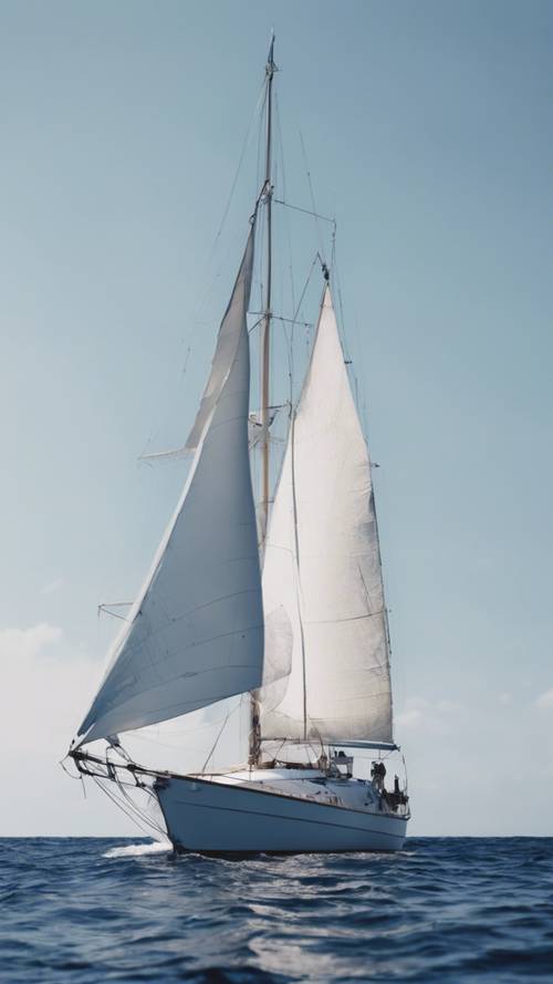 A close-up of a white sailing boat on the navy blue sea