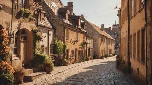 A charming, cobblestone-lined European town, bathed in the warm glow of a mid-afternoon sun. Tapeta [0f2209be9c104ed6a02f]