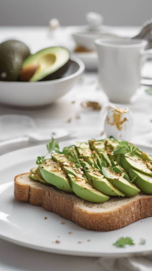 An avocado toast set on minimalist white breakfast table