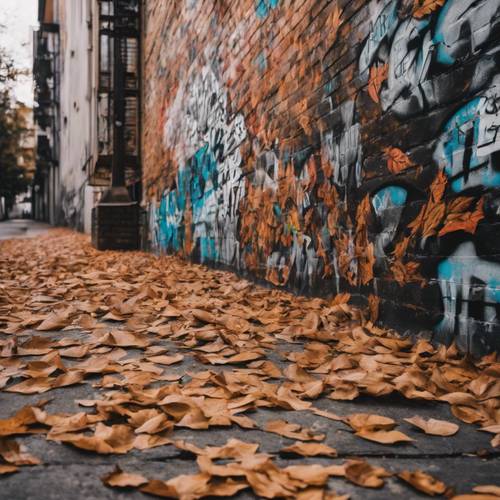 Pared de la calle cubierta con un grafiti monocromático de hojas cayendo.