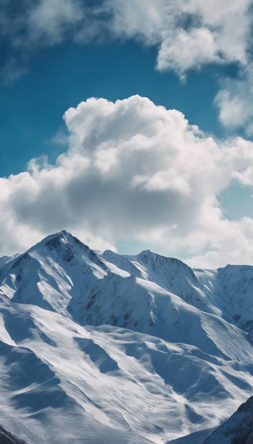 ภูเขาที่ปกคลุมด้วยหิมะภายใต้ผืนผ้าใบอันตระการตาของเมฆสีน้ำเงินแซฟไฟร์และสีขาว