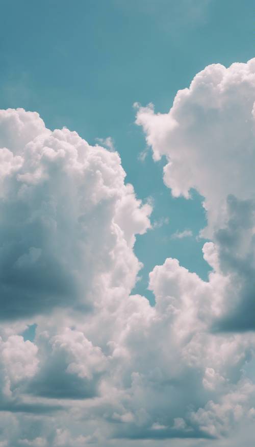 ふわふわ雲がゆっくりと浮かぶ、パステルブルーの空