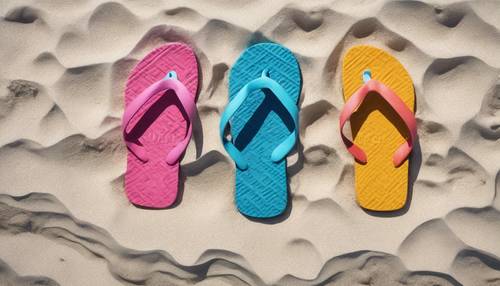 A pair of colorful flip flops lay on the white beach sand, forgotten in haste. Tapeta [5320038eabae4ea8b22d]
