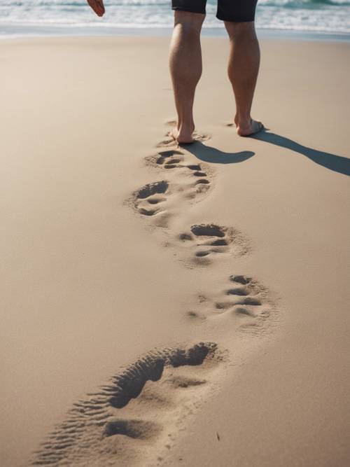 Person leaving heavy footprints on a beach, indicating weight loss progress.
