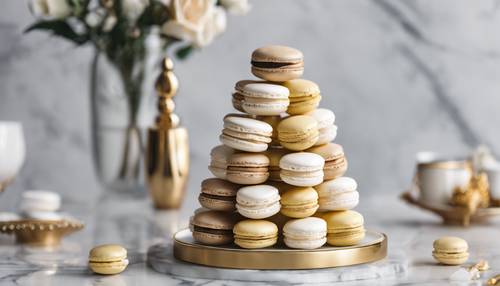 A beautiful white and gold macaron tower on a marble table.”