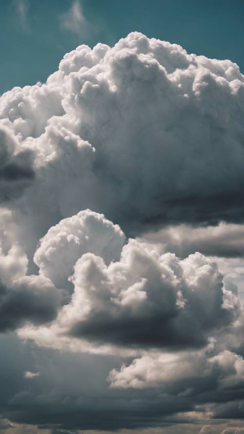 A dramatic scene of storm clouds clearing to reveal bright white clouds. Tapet [368530d23e234ef4b2dc]