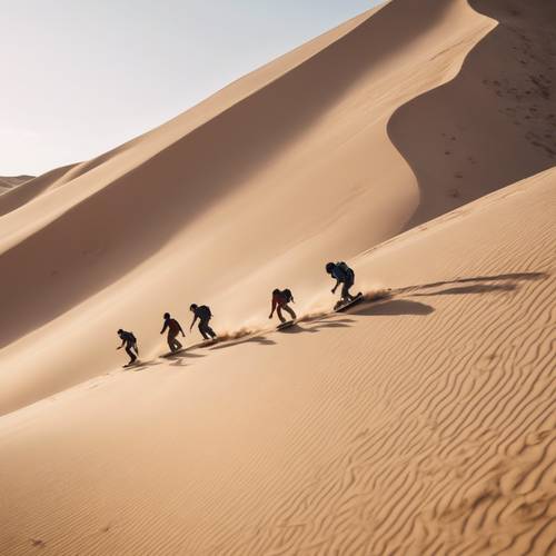 A group of adventurous people sandboarding down a large, steep dune in the desert.