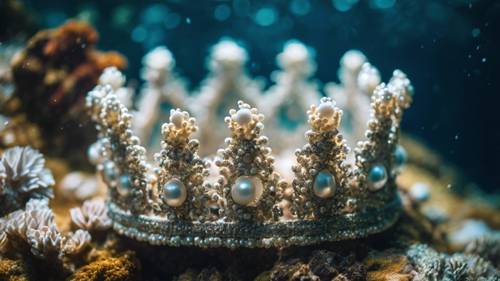 An underwater crown made from pearl-engrusted shells amongst a coral reef.