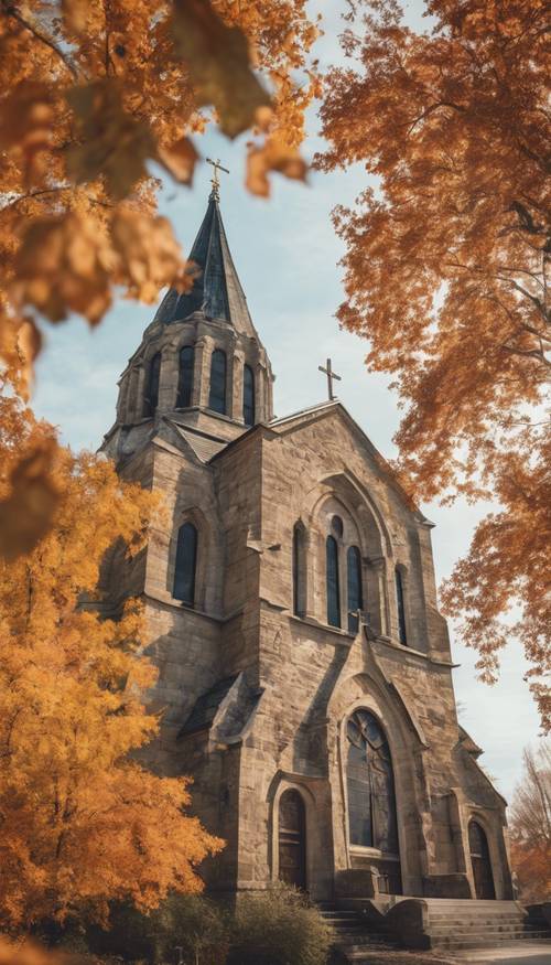 An old stone Christian cathedral with Fall foliage in the background.