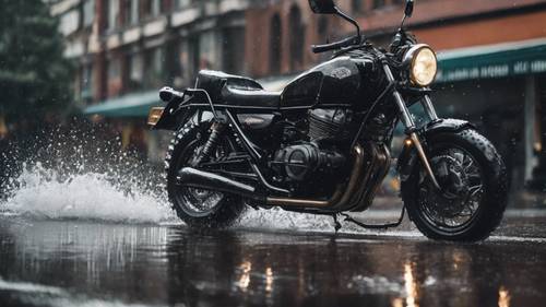 A shiny black motorcycle zooming past on a rainy day, leaving sprays of water behind.