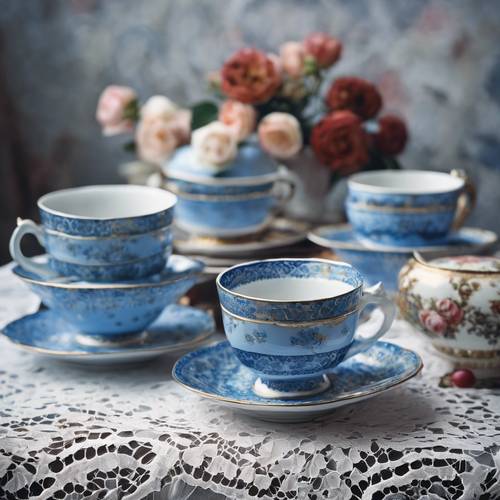A still-life painting of vintage blue teacups stacked haphazardly on a lace tablecloth.