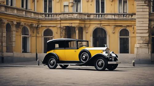 Vintage 1920s yellow Rolls-Royce with old-style architecture in the backdrop.