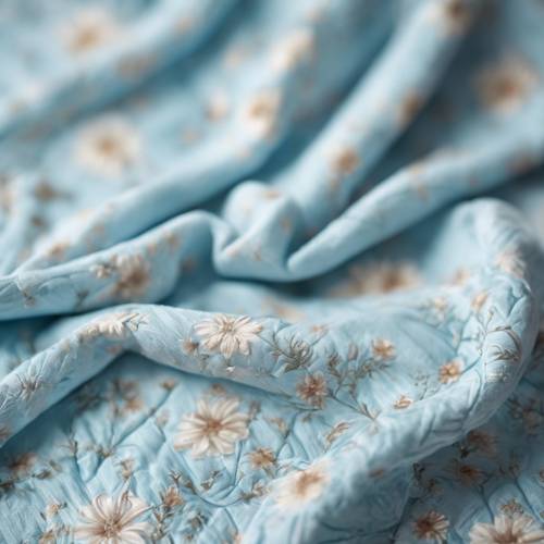 A soft baby blanket with a sweet light blue floral pattern.