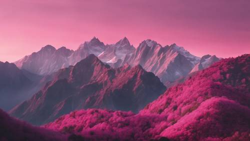 A striking mountain range at dawn, each peak taking on a different shade of pink in an ombre effect.