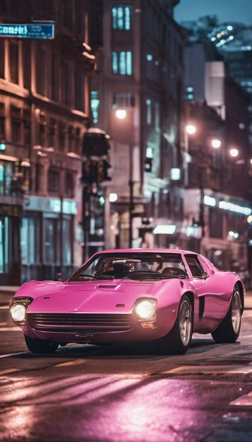 A pink metallic sports car racing down a city street at night.