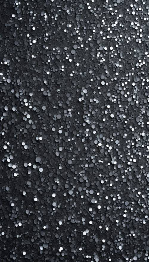 Um padrão abstrato de glitter cinza escuro luminosamente brilhante espalhado uniformemente pela tela.