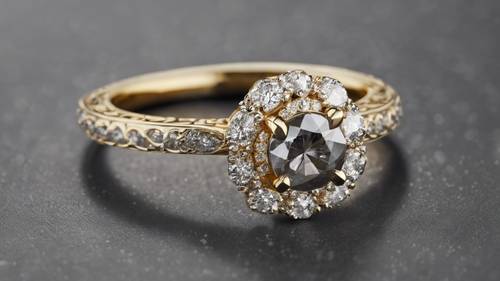 A gray diamond ring with halo design in yellow gold.