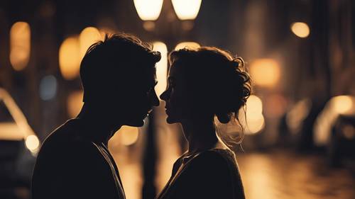 Silhouette of a couple with their foreheads touching, gazing into each other's eyes under the dim light of a street lamp