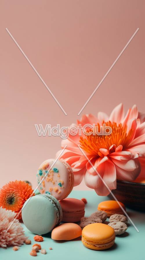 Macarons coloridos y hermosas flores sobre fondo rosa