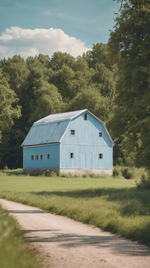 A pastel blue barn in a peaceful countryside during summertime.