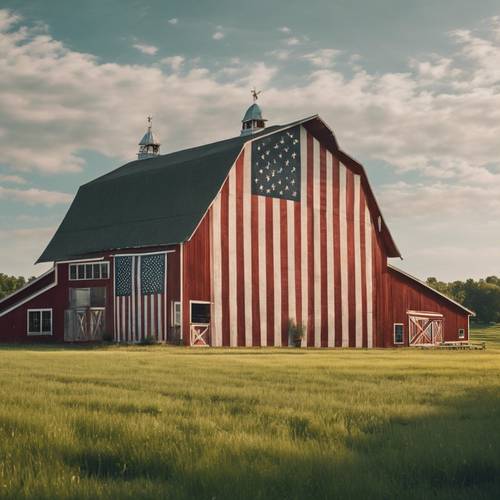 A rustic barn adorned with large American flag, surrounded by green farmland under a clear summer sky, celebrating the peaceful countryside on Fourth of July.