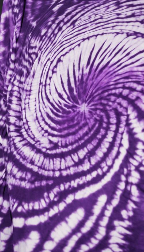 A swirling pattern of purple and white tie-dye on a cotton t-shirt.