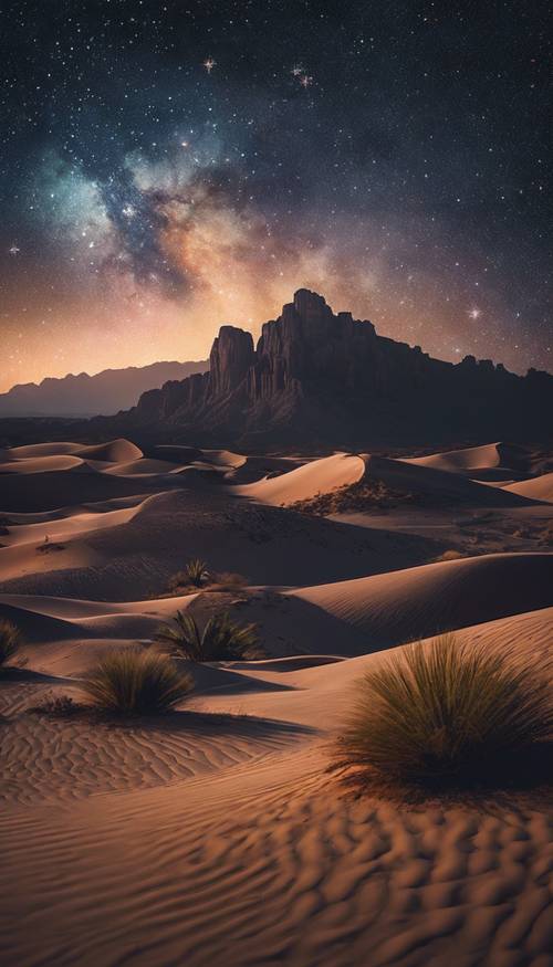 Un panorama di mezzanotte del deserto sotto il cielo di velluto tempestato di stelle.