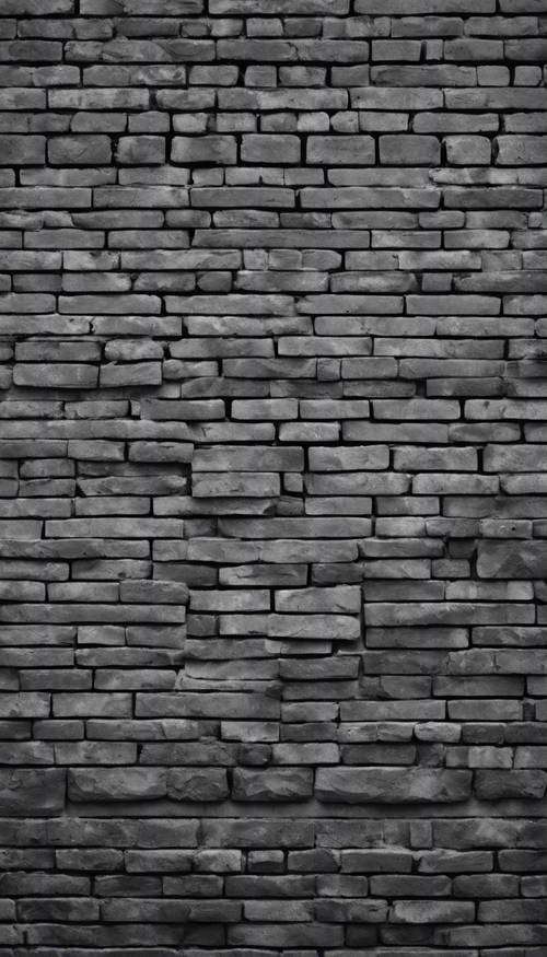 温暖的日光下的黑灰色砖墙。