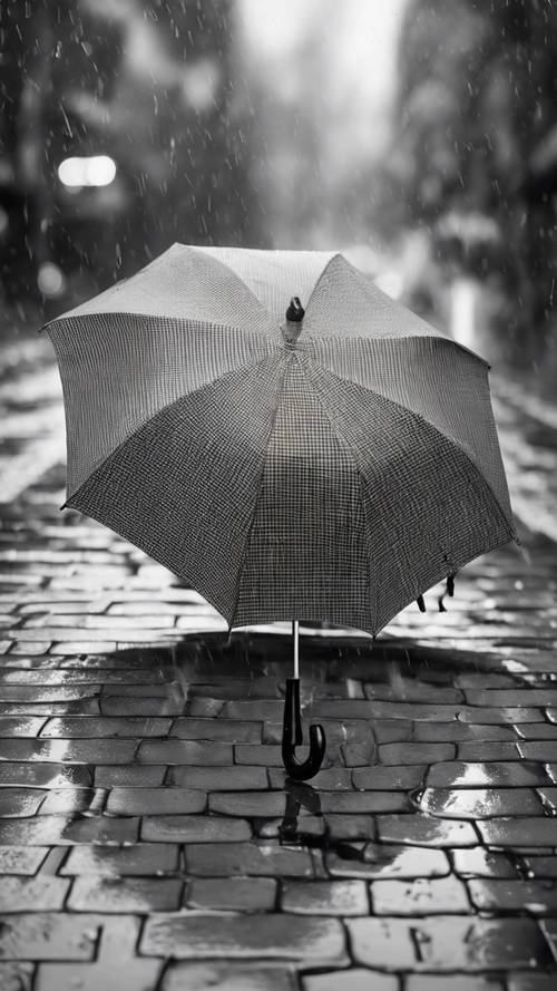 Un ombrello scozzese bianco e nero aperto su uno sfondo piovoso.