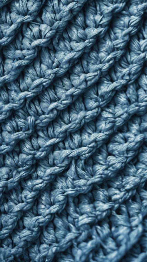 日光下蓝色纹理编织织物的特写图像。