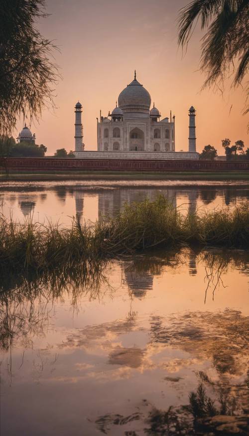 Une vue du coucher de soleil sur le Taj Mahal se reflétant dans la rivière Yamuna.