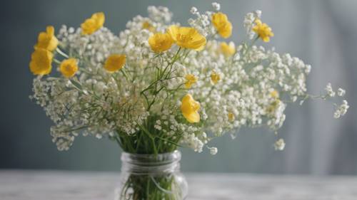 A stem of buttercups tangled with baby's breath flowers in a bouquet.