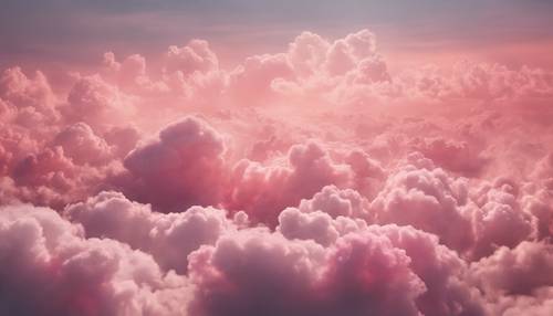 Uma paisagem de nuvens de fantasia mostrando nuvens fofas com um deslumbrante ombre rosa a pêssego, criando um cenário de conto de fadas.