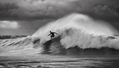 Dramatic black and white depiction of a surfer riding a high wave under a stormy sky.