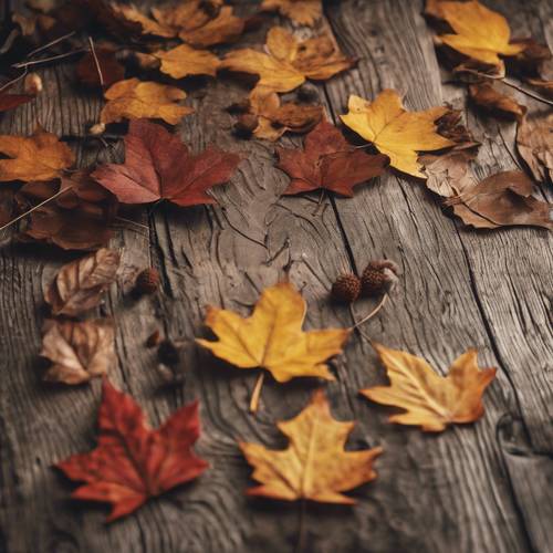 秋の葉っぱが描かれた素朴な木製テーブルの壁紙