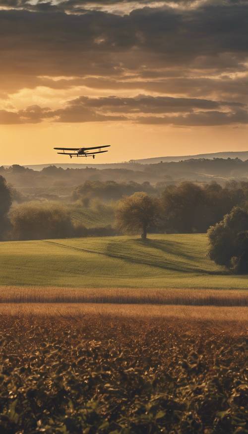 An antique airplane soaring over a farm at dawn.