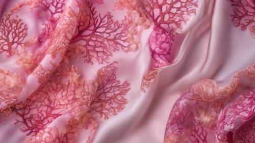 An intricate underwater coral pattern, colored with various shades of pink, on a silk scarf.