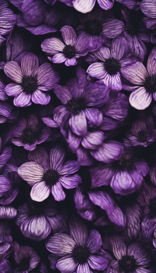 An intricate floral pattern composed of black and purple petals, tightly woven like a tapestry