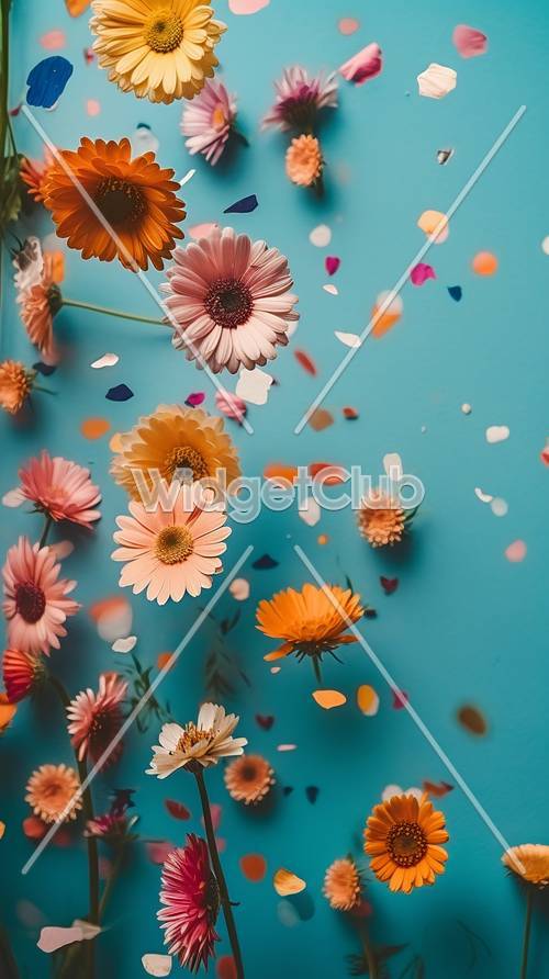 Kolorowe kwiaty i płatki unoszące się na niebiesko