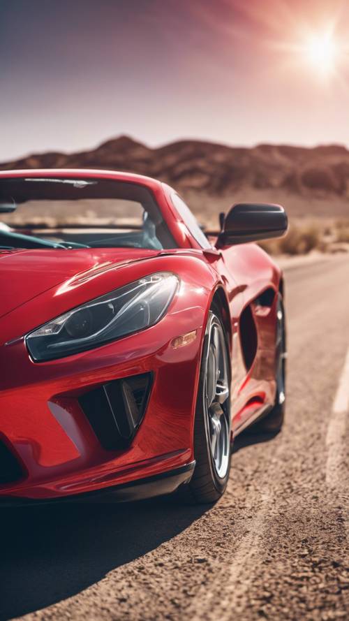 A shiny red sports car racing on a desert highway in the midst of a sunny day.