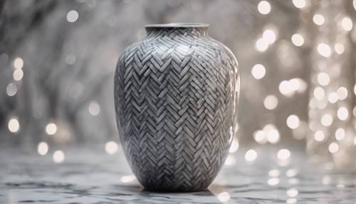 A gray herringbone pattern neatly painted on a ceramic vase.