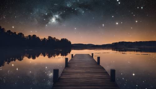 A tranquil lake under a starry sky on a clear night.