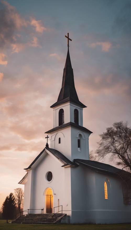 Sebuah gereja berwarna putih di pedesaan dengan latar langit senja, dengan salib menyala di puncak menara.