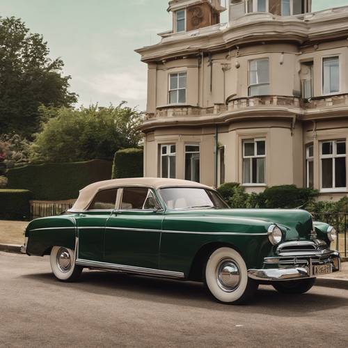 A deep green classic car parked by a beige Victorian-style house.