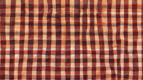 Старомодный красно-оранжевый клетчатый узор, подобный тому, который можно увидеть на стильных фланелевых рубашках.