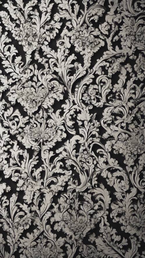 Un intrincado patrón de damasco en blanco y negro que cubre toda una pared en una casa antigua.