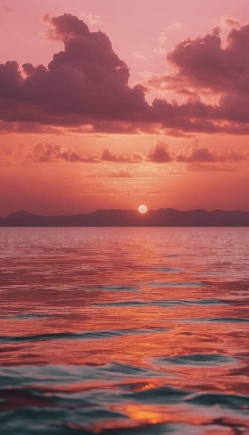 令人驚嘆的日落，呈現出粉紅色和橙色的色調，照亮了下面平靜的大海。