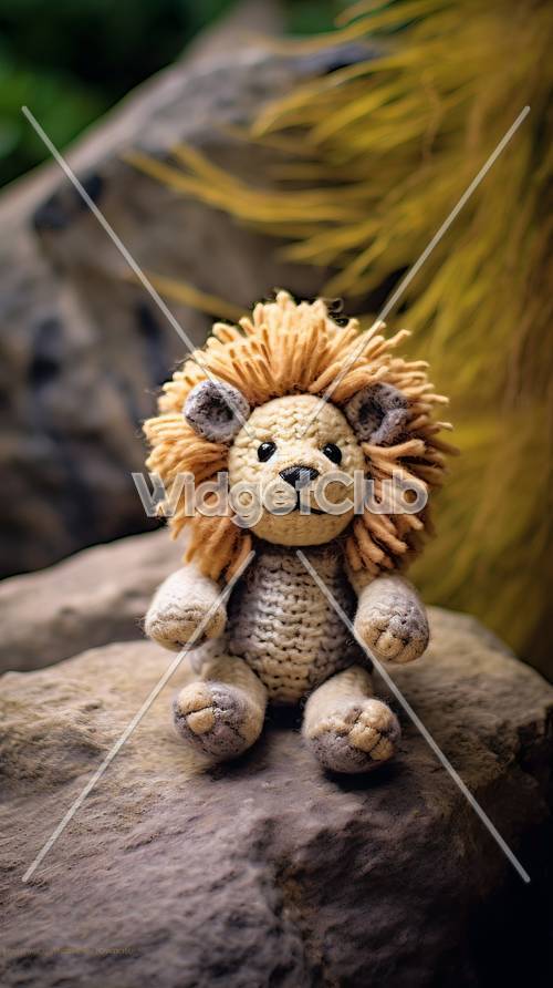 צעצוע אריה סרוג וחמוד יושב על סלע