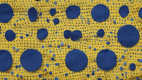 A pattern of blue polka dots on a yellow fabric.